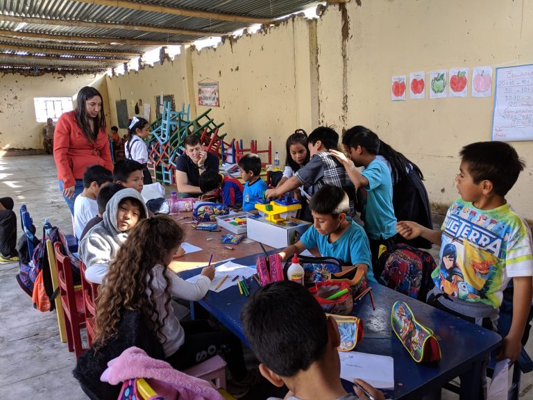 Chris and Rubi with students at 'Niños del Oro' community center.