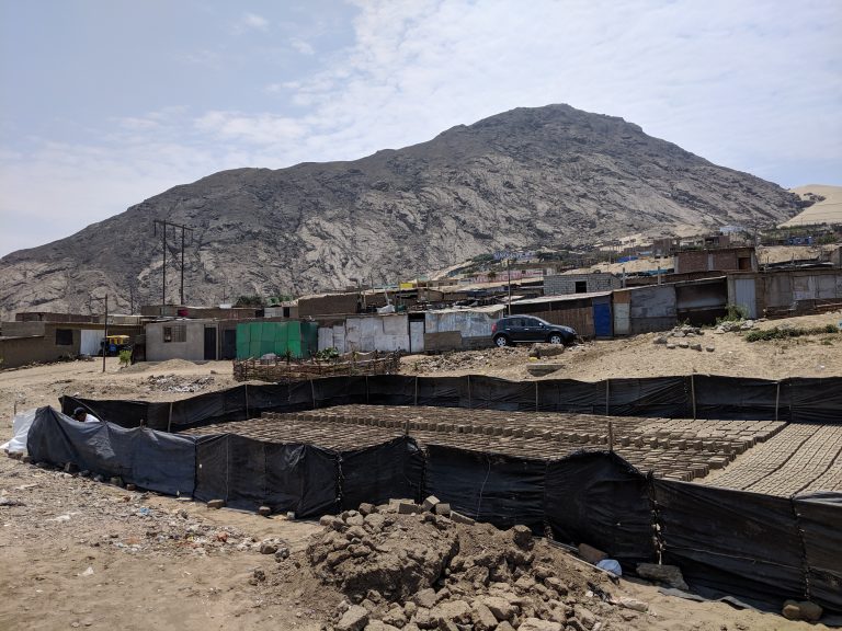 Shantytown houses in La Esperanza with adobe bricks being dried.